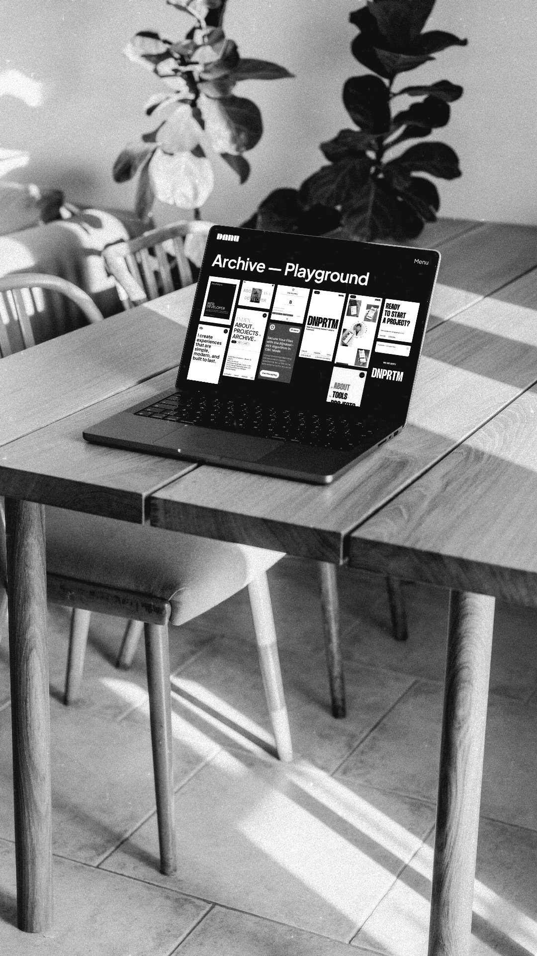 Laptop on a desk displaying a website mockup by Danu Pratama